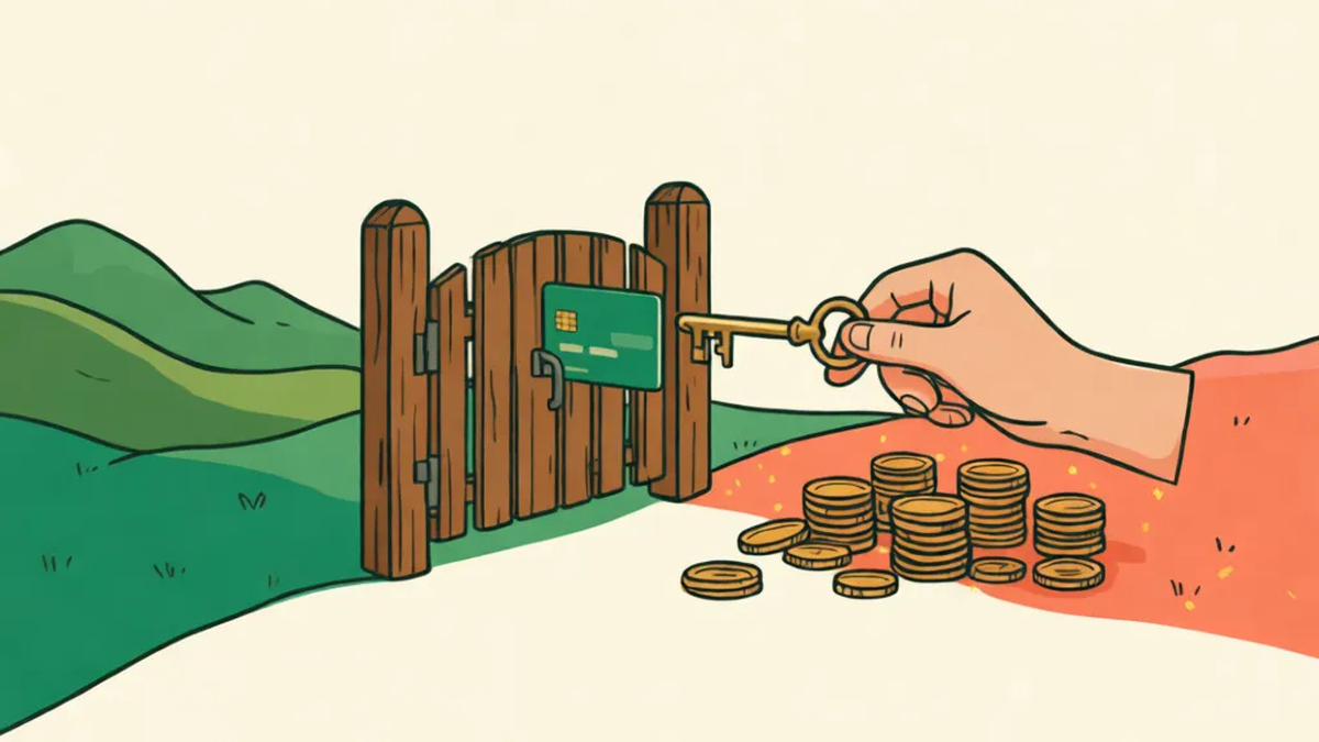 A bank card stuck at a small wooden gate between two fields while a hand brings a key to open it, with coins waiting on the other side.
